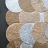 Luxury custom designer rug with overlapping tan, beige, and white faux hide patches.