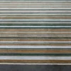 Close-up of Jet Stream Wool 15357, a luxury designer rug with green, brown, and white stripes.