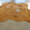 Portal Hide 25165 high-end designer rug, tan handmade hide with oval cutout on gray floor.