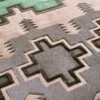 Close-up of luxury designer rug Custom Hide 26748, featuring geometric patterns in gray, beige, and green with a high-end textured finish.