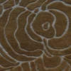 Close-up of a high end designer rug with raised brown wool shapes and recessed gray detailing.
