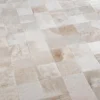 A close-up of high end designer rugs in beige and cream squares with a subtle texture.