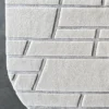 Close-up of luxury designer Tower Silk Wool 26836 high-end rug, light gray with geometric textures on a dark floor.