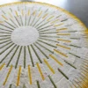 Luxury designer round rug Shadowplay Hide 26287 with a radial sunburst pattern on grey.