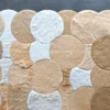 Luxury designer rug featuring circular tan, beige, and white faux fur patches on gray.