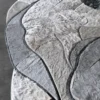 Close-up of luxury designer rug, Custom Hide 29456, with textured grey handmade hide and high-end abstract design.