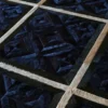 Close-up of luxury custom designer rug, dark textured hide with geometric lines and high-end finish.