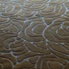 Close-up of Bloom Wool 15897, a luxury handmade wool designer rug in brown and gray abstract swirls.