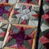 Close-up of the Fancy Hide 16177 designer rug, showcasing high end geometric star patterns handcrafted from luxury multicolored hide.
