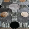 Symmetrical geometric designer rug with colorful circles on Atlas Hide 30060's luxury textured surface.