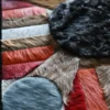 Close-up of Atlas Hide 15902 luxury designer rug with geometric shapes on a high-end handcrafted hide and faux fur textured surface.