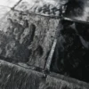 Close-up of handmade luxury designer hide rug with black and dark gray fur squares sewn together.