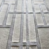 Luxury designer rug in beige and gray silk wool with raised geometric handmade pattern.