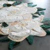 Luxury designer rug Sweet Hide 26095 with a large white floral motif on gray floor.