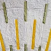 Luxury designer rug with white faux fur panels, yellow and green stripes, and a geometric pattern inspired by Shadowplay Hide 26287.