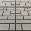 Luxury designer wool rug in gray with black geometric grid, high-end handmade style.