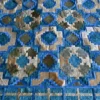 Crossroads Hide 15073 high end designer rug with geometric blue, teal, and beige patchwork in luxury handmade hide.