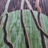 Luxury custom wool rug with vertical brown and green lines and a semicircle accent.