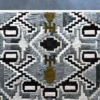 Luxury designer rug with geometric diamond and rectangular shapes in black, gray, white, and olive green from Custom Hide.