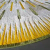 Close-up of a luxury designer rug, Shadowplay Hide 26287, with a circular cut and vivid streaks on dark handmade hide.