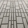 Luxury custom handmade wool rug with geometric pattern of intersecting dark lines.