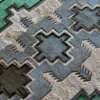Geometric luxury designer rug with star and bird motifs in gray, beige, green hide.