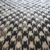 A close-up of Blackdog Wool 15851 shows a luxury designer houndstooth handmade wool rug in black, gray, and beige.