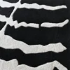 Luxury designer rug with a black base and abstract white textured lines in handmade wool.