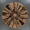 Luxury round designer rug, geometric radial pattern, brown and beige hide on gray floor.