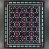 Aubusson Hide 16290 luxury designer rug with red, white, and black motifs on gray floor.