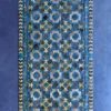 Luxury designer rug, rectangular with geometric blue, gray, and white pattern on a high-end solid blue background.