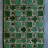 Ignition Hide 16101 is a luxury designer rug with green shapes on a gray textured hide.