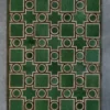 The Ignition Hide 16101 is a luxury designer rug with geometric green motifs on gray.