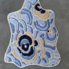 Luxury designer rug with wavy blue, beige, and navy swirls on grey silk-wool.