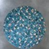 The Fez Hide 28129 is a luxury handmade designer rug featuring a circular blue pattern with geometric pink, white, and orange accents.