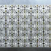 Luxury designer rug featuring geometric diamonds and hexagons on gray hide background.