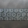 The Cecelia Hide 27642 luxury designer rug features octagons and diamonds on a metallic textured surface, ideal for high end interiors.
