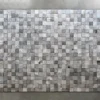 A grid of small, square, gray tiles resembles luxury custom rugs for high-end interiors.
