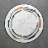 Luxury designer rug with round abstract pattern, textured white and curved green, orange, beige bands on grey, perfect for high-end spaces.