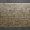 Luxury custom hide rug with a mosaic of brown, beige, and green tiles on dark gray.