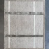 Luxury designer wool and silk rug in beige with white and gray stripes on dark floor.