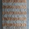 Designer Flow Hide 29116 luxury handmade rug with brown and blue waves on gray floor.