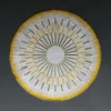 Shadowplay Hide 26287 designer rug with gold, green, and white radial pattern on dark gray.