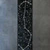 A luxury custom hide rug in black with white constellation pattern, perfect for high-end designer interiors.