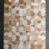 Luxury custom rug with overlapping gold and silver circles on dark gray, inspired by high end designer rugs.