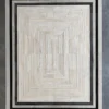 Faceta Hide 15388 luxury designer rug tiles create a geometric pattern with black borders on a gray high-end floor.