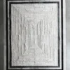 Faceta Hide 15388 luxury designer hide rug with bold black and white borders on concrete floor.