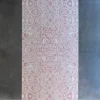 Luxury designer rug Urushi Wool 28585 in pink and white on concrete floor, handmade wool.
