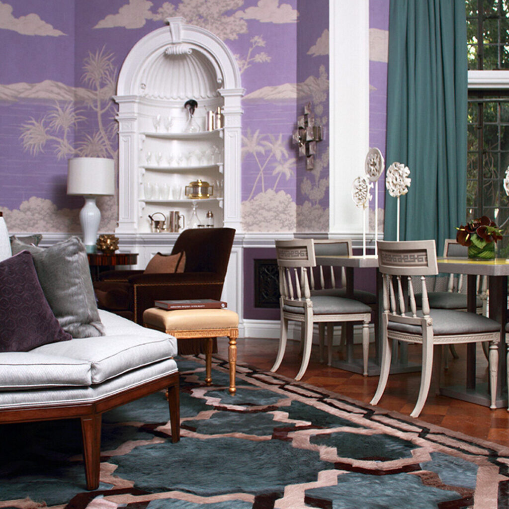 A living room with purple wallpaper and a designer rug accentuating the elegant decor.