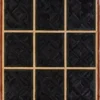 A grid of nine black textured squares on brown showcases a luxury designer hide rug.